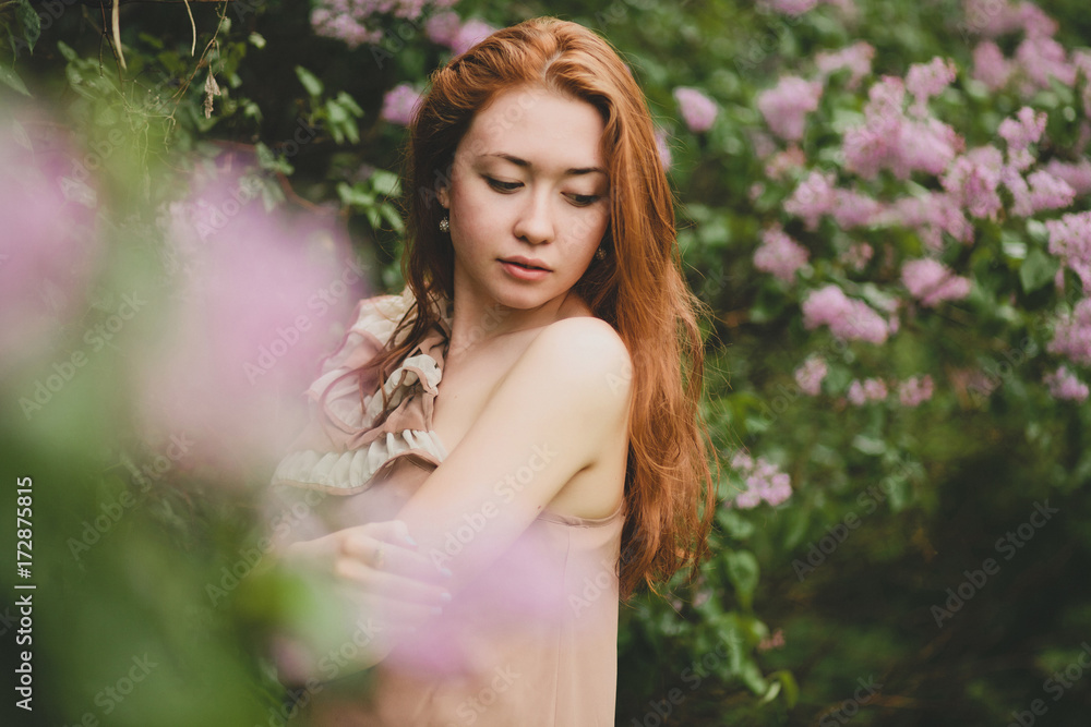 Portrait of beautiful young woman in blossom garden Portrait of beautiful young woman in blossom garden