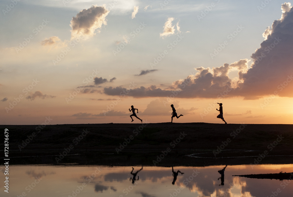 Three boys running a race in a wonderful ladscape Three boys running a race in a wonderful ladscape