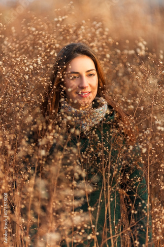 Young happy woman woman standing in a field