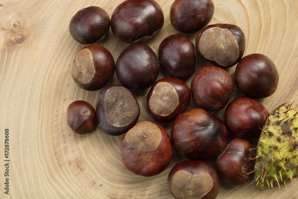 Group of chestnuts in a wooden background Group of chestnuts in a wooden background