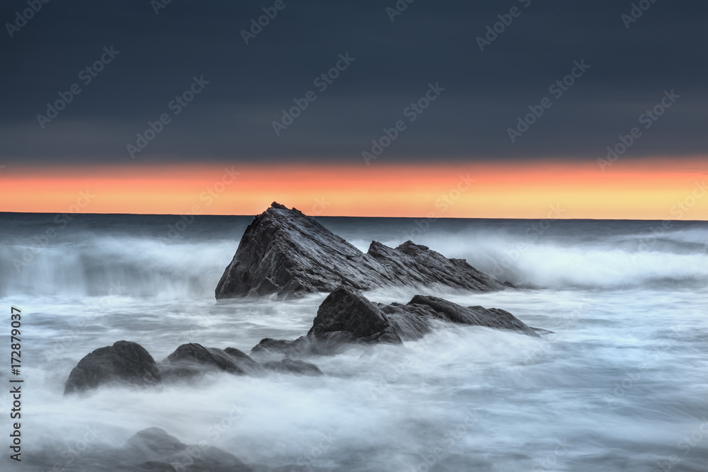 Bude, Cornwall, rocks at sunset with waves shots on slow shutter