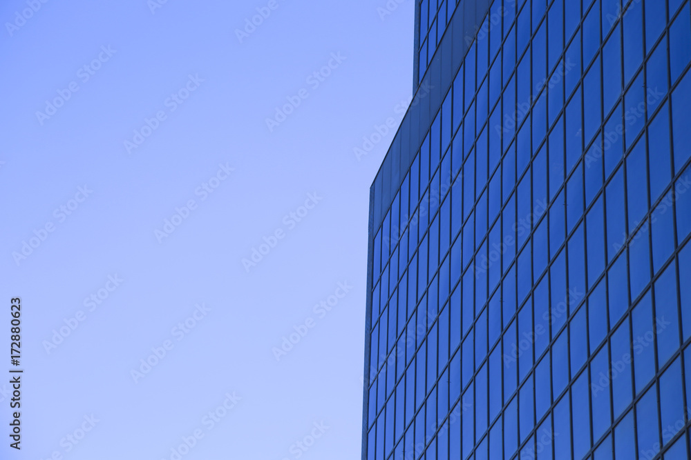 Office building with glass windows and blue sky Office building with glass windows and blue sky