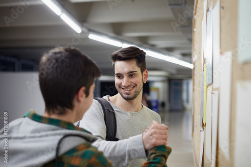 Two young students congratulating the grades of the university
