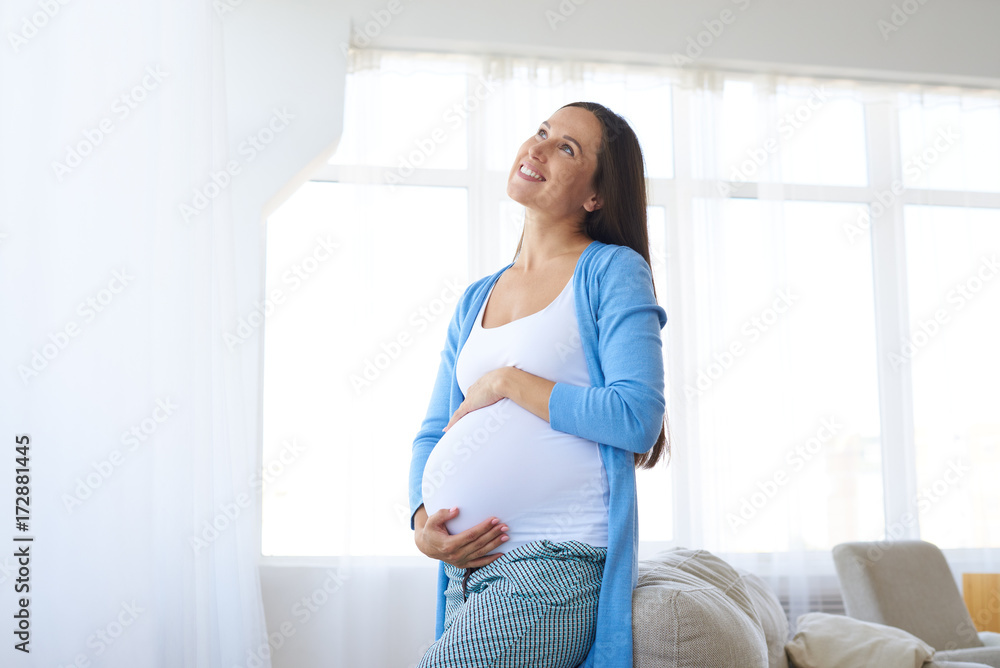 Thoughtful pregnant woman looking up Thoughtful pregnant woman looking up