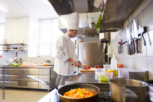 male chef cooking food at restaurant kitchen