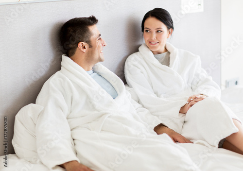 happy couple in bed at home or hotel room