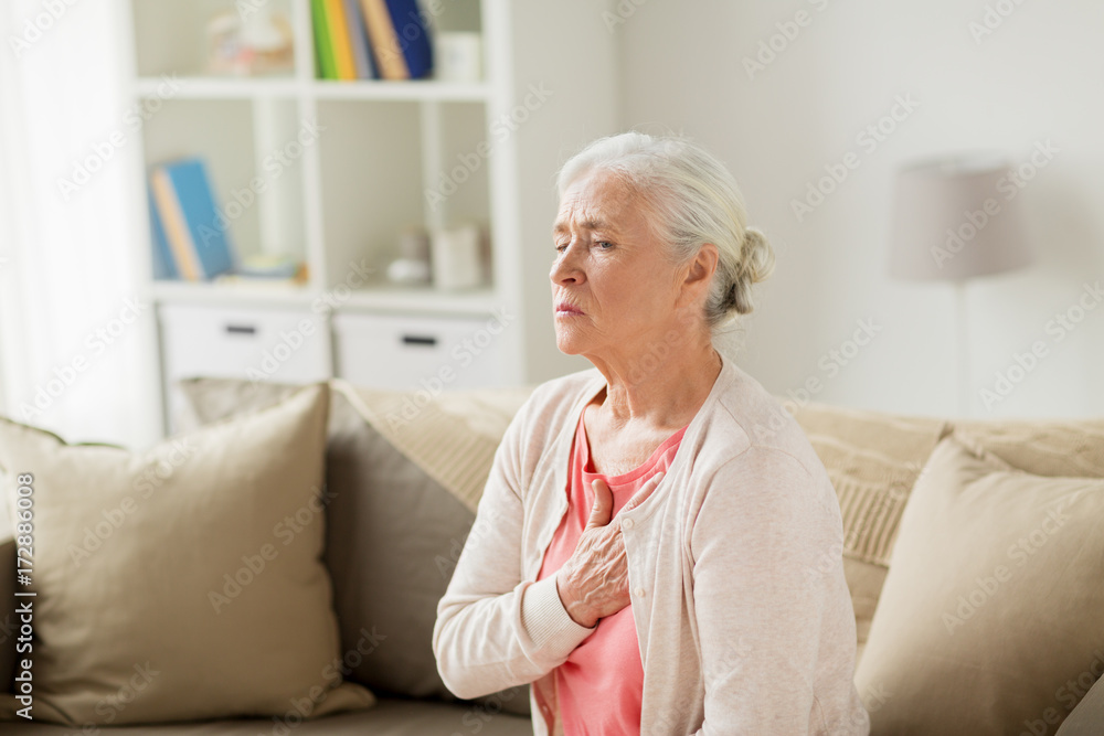 senior woman suffering from heartache at home senior woman suffering from heartache at home