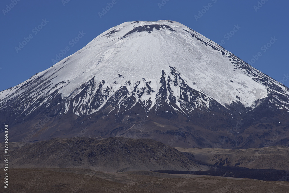 Ice covered peak of Volcano Parinacota in Lauca National Park high on the Altiplano of northern Chile. Ice covered peak of Volcano Parinacota in Lauca National Park high on the Altiplano of northern Chile.