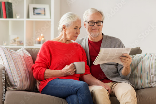 happy senior couple reading newspaper at christmas photo