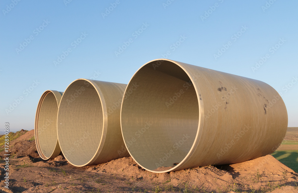 Large concrete pipes waiting for infrastructure work. Large concrete pipes waiting for infrastructure work.