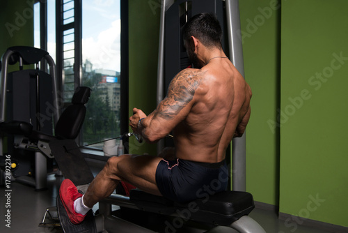 Athletic Man Doing Exercise for Back in Gym © Jale Ibrak