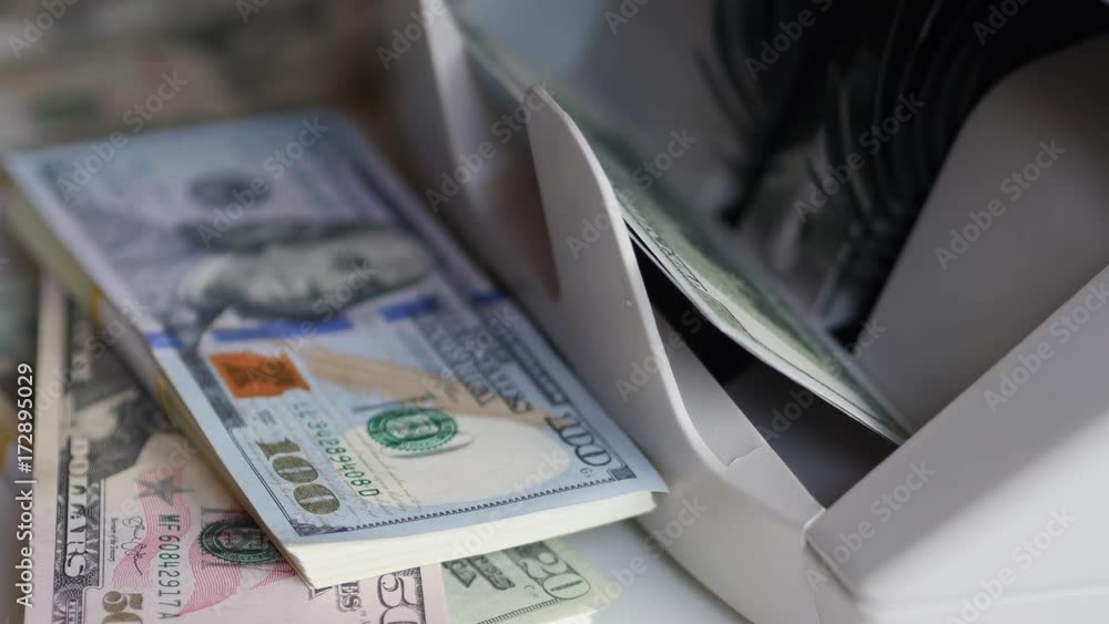 Counting US Dollars Banknotes On Currency Counter Machine Counting US Dollars Banknotes On Currency Counter Machine