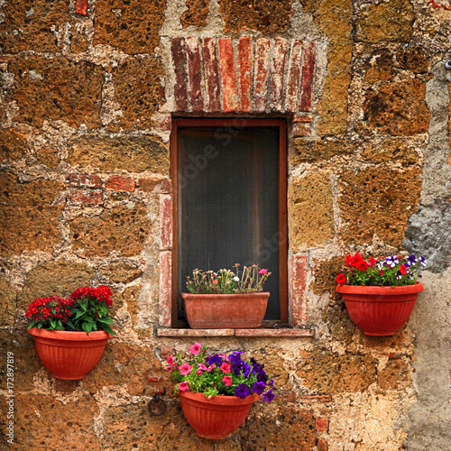 Small italian window with nice flowers, Italy