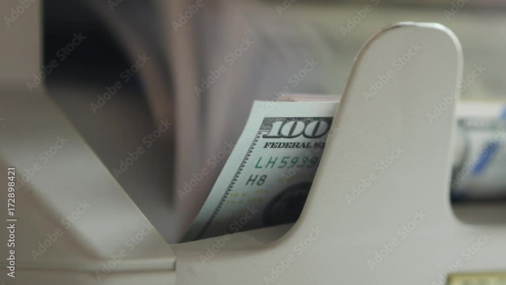 Counting US Dollars Banknotes On Currency Counter Machine Counting US Dollars Banknotes On Currency Counter Machine