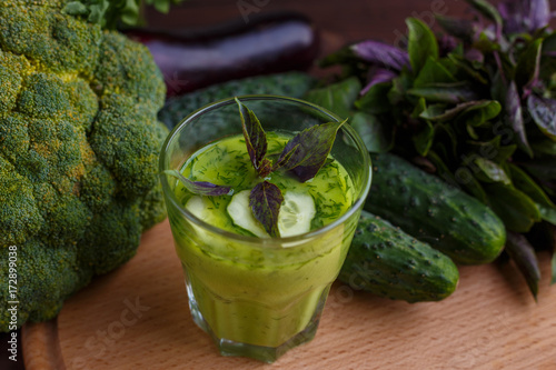 Fototapeta Naklejka Na Ścianę i Meble -  Diet concept, healthy lifestyle, low calorie detox and dietary food. Blended refreshing green smoothie with ingredients on wooden table