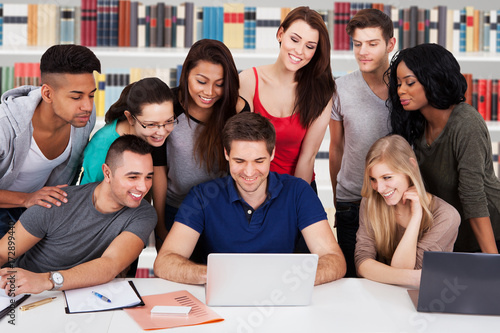 University Students Using Laptop Together