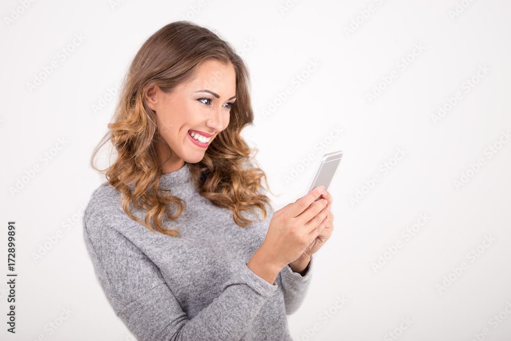 Beautiful woman texting on smartphone Beautiful woman texting on smartphone