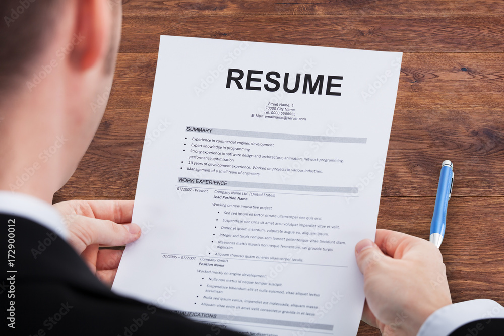 Businessperson Looking At Resume Businessperson Looking At Resume