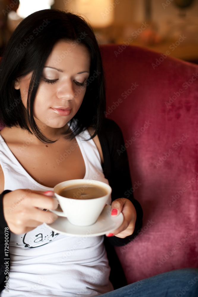 young woman sitting in a cafe drinking coffee young woman sitting in a cafe drinking coffee