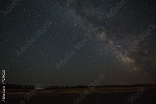 The Milky Way band with the galactic core setting on the horizon of Yellowstone National Park.