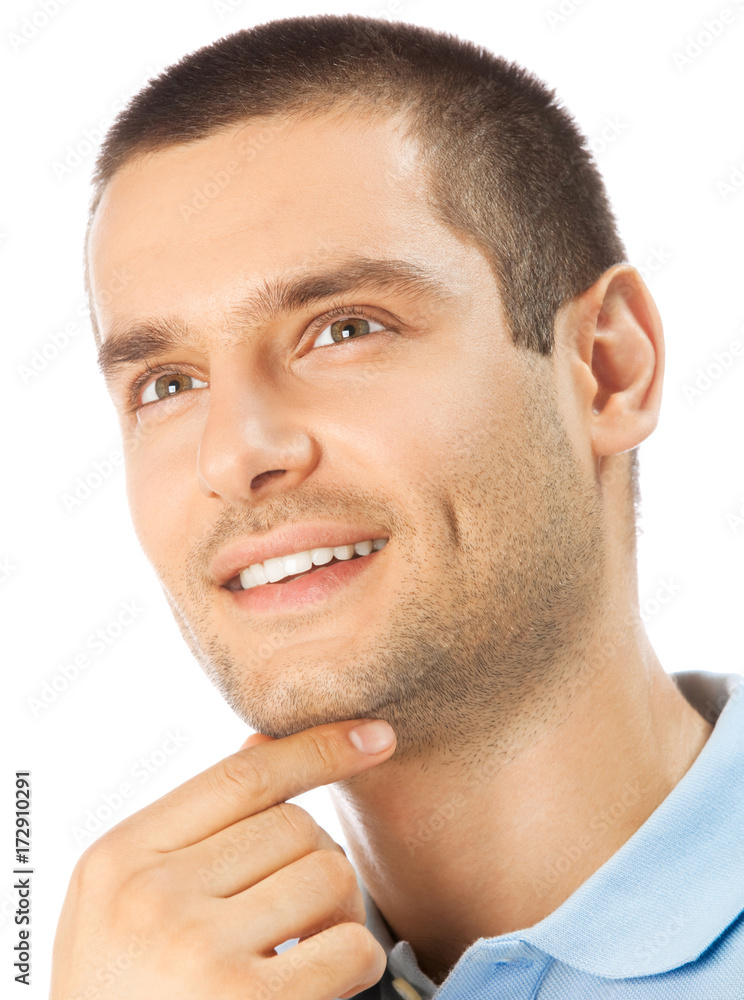 Obraz premium Cheerful thinking young man, over white