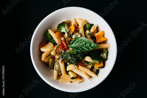 Pasta Primavera on black background, horisontal with negative space photo