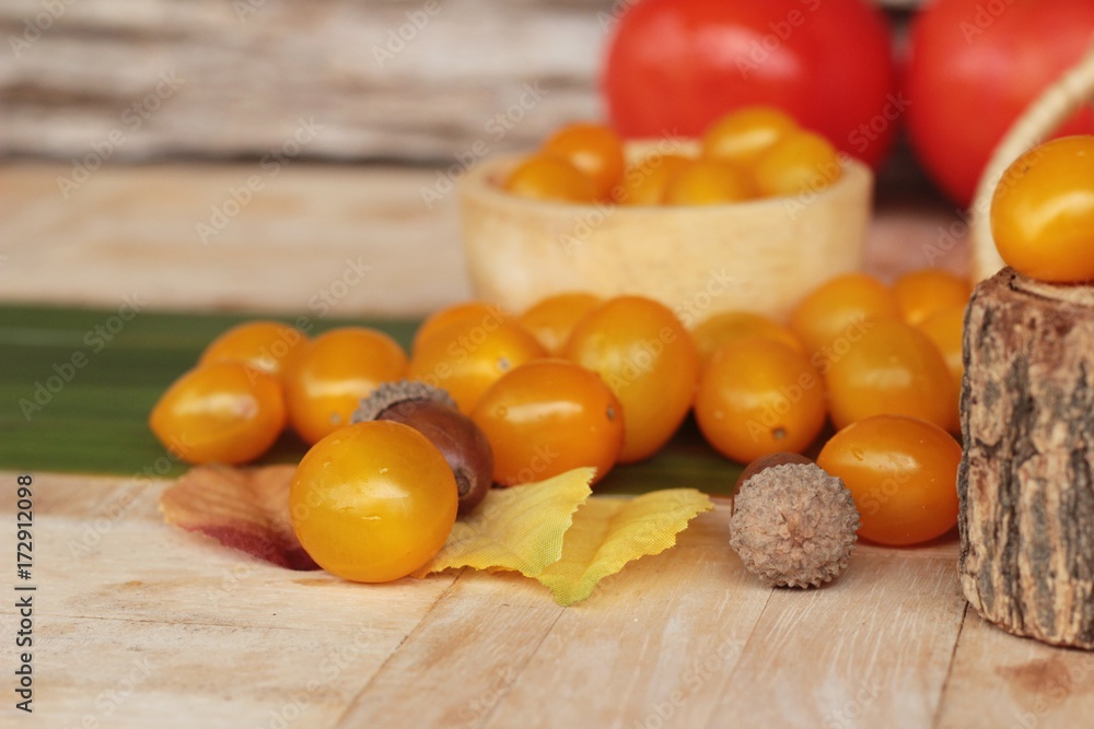 Fresh yellow tomatoes organic on wood background Fresh yellow tomatoes organic on wood background