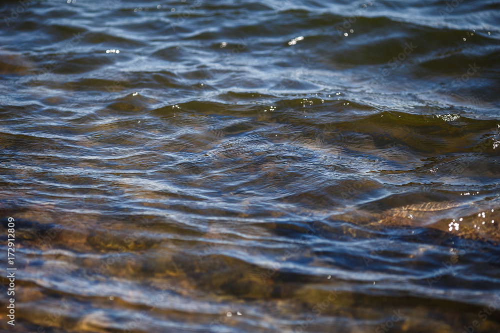 Water surface with ripples and reflections texture background Water surface with ripples and reflections texture background