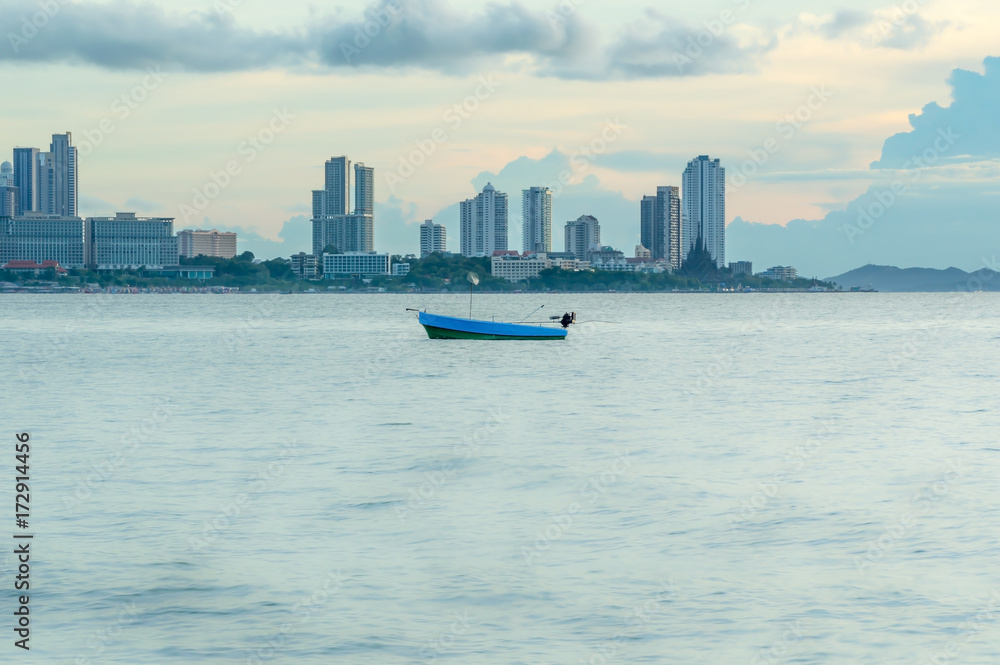 Fishing boat on the sea view of city.