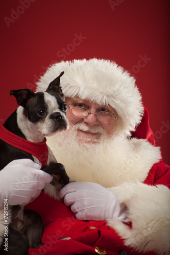 Santa sits with puppy dog