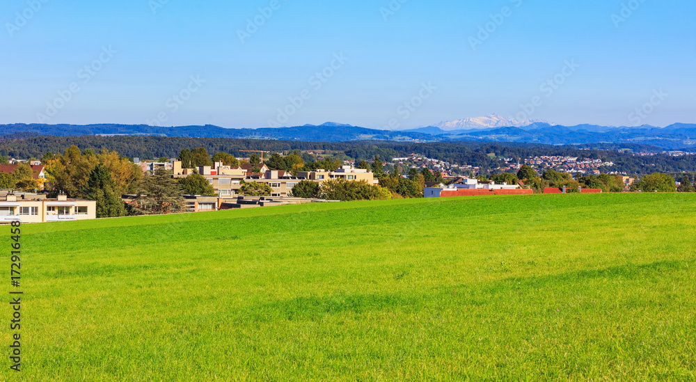 Countryside view in the Glatt Valley region of the Swiss canton of Zurich, summits of the Alps in the background