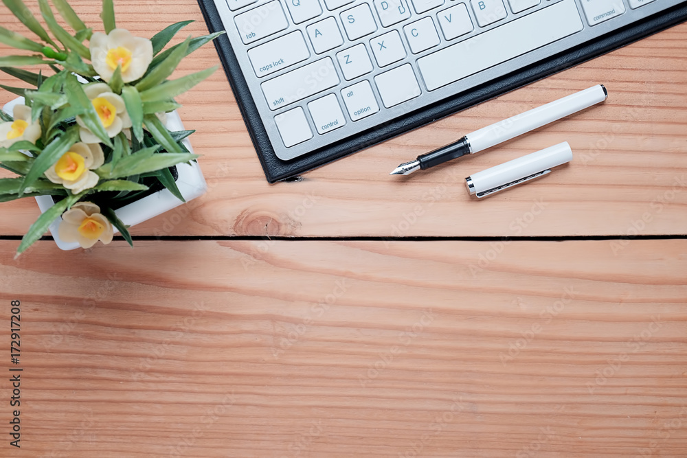 Office desk table with pen,keyboard ,smartphon,notebook, cup of coffee and flower. Top view with copy space (selective focus). Office desk table with pen,keyboard ,smartphon,notebook, cup of coffee and flower. Top view with copy space (selective focus).