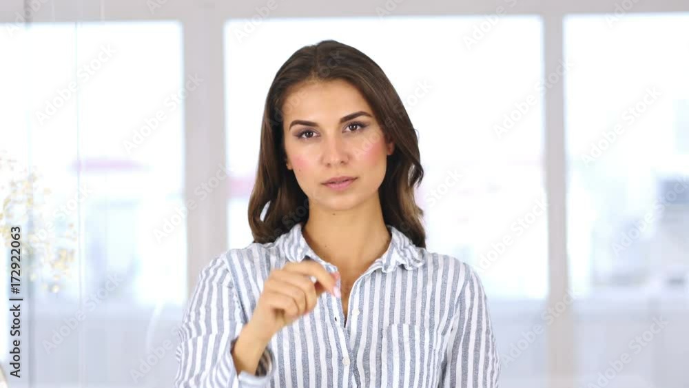 Portrait of Woman Pointing at Camera in Office Portrait of Woman Pointing at Camera in Office