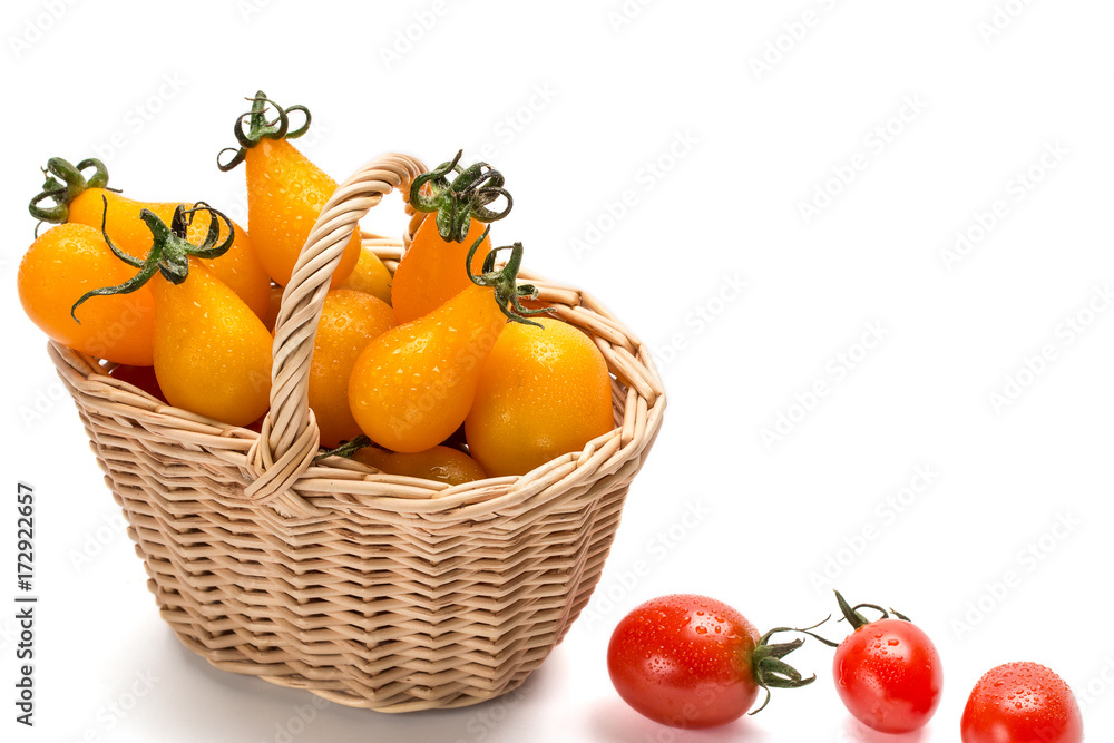 Red tomatoes in basket isolated on white background Red tomatoes in basket isolated on white background