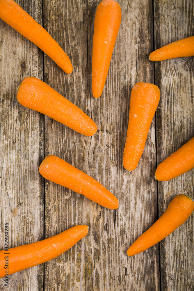 Ripe carrots on a white wooden table. Ripe carrots on a white wooden table.