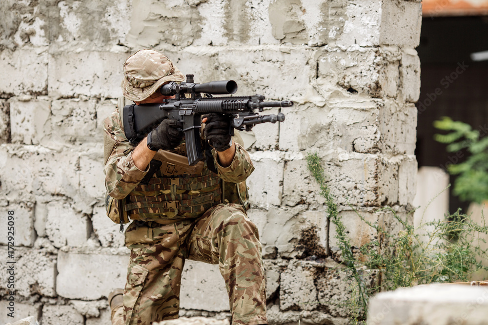 Fototapeta premium Portrait soldier or private military contractor holding sniper rifle.