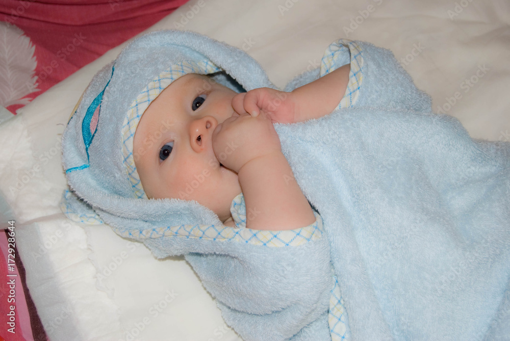 Newborn Baby boy after bath in a blue terry towel
