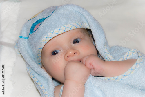 Newborn Baby boy after bath in a blue terry towel