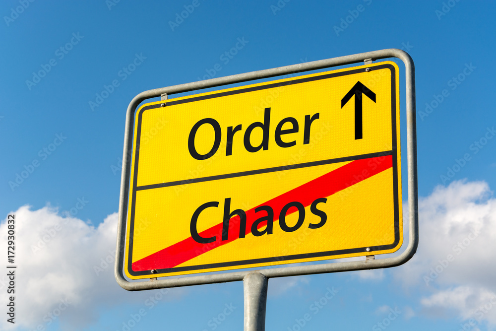 Yellow street sign with Order ahead leaving Chaos behind Yellow street sign with Order ahead leaving Chaos behind