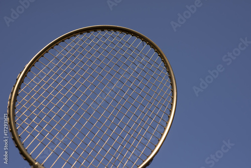Badminton golden racket sky blue. © mema