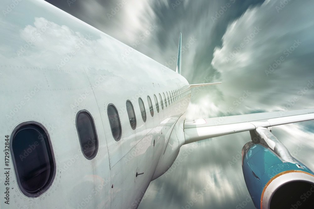 Fototapeta premium Airplane at fly on the sky with clouds