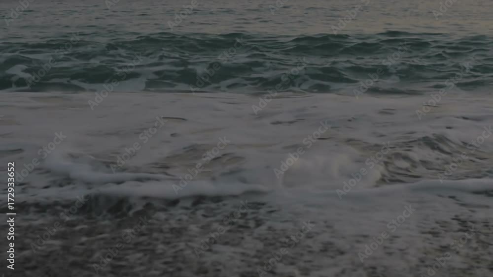 Foamy sea waves and a pebble beach Foamy sea waves and a pebble beach