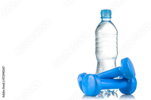 Fitnes symbols - red dumbbells, a bottle of water and a towel. The concept of a healthy lifestyle photo