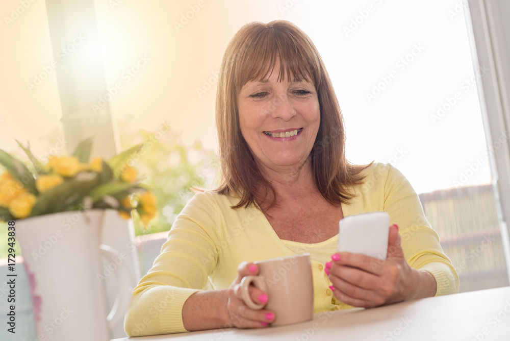 Mature woman using a mobile phone, light effect Mature woman using a mobile phone, light effect