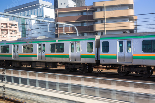 Train in motion on the railway of Tokyo, Japan