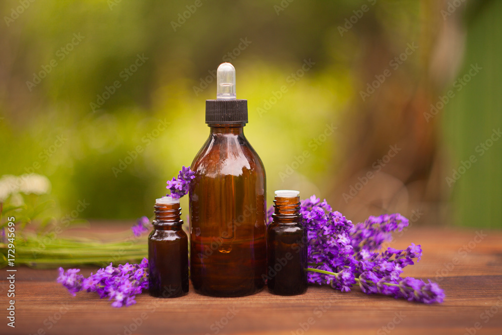 Essence of lavender flowers on table in beautiful glass jar Essence of lavender flowers on table in beautiful glass jar