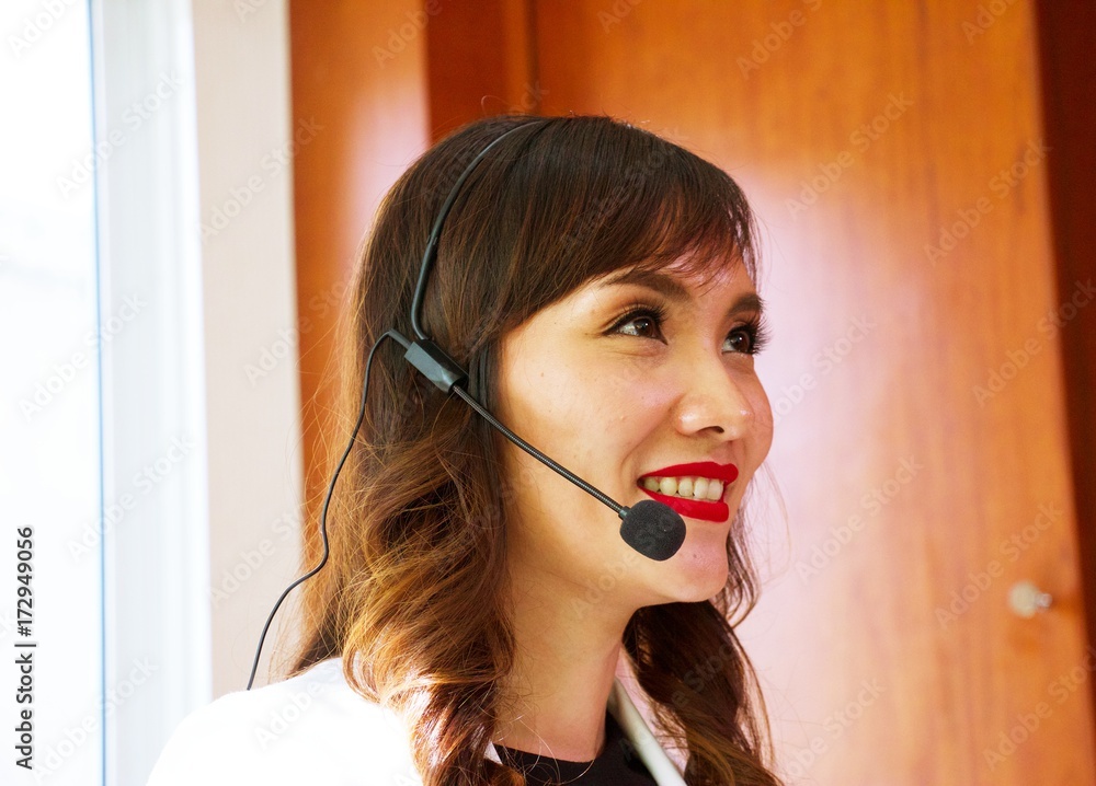 Asian woman with headset as calling centre or help desk business concept Asian woman with headset as calling centre or help desk business concept