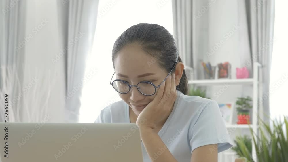 Asian woman woking on computer laptop at home Asian woman woking on computer laptop at home