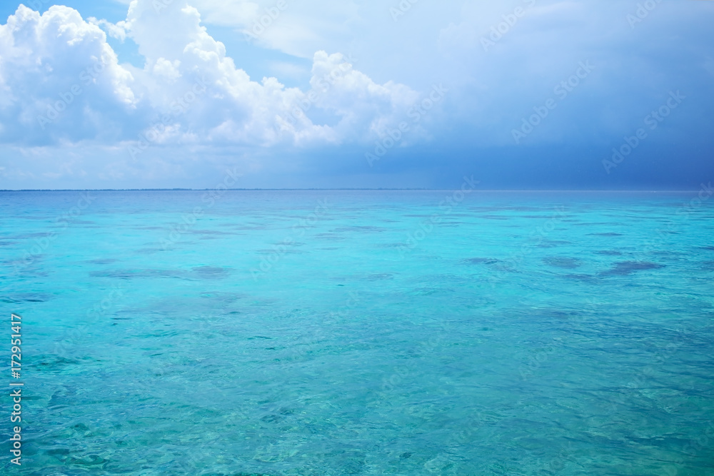 Thunderstorm and blue sky over the ocean