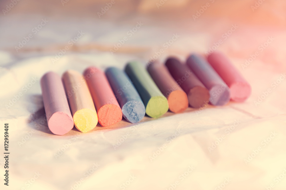 Set of multicolored pastel pencils on a light background. Selective focus. Toning Set of multicolored pastel pencils on a light background. Selective focus. Toning